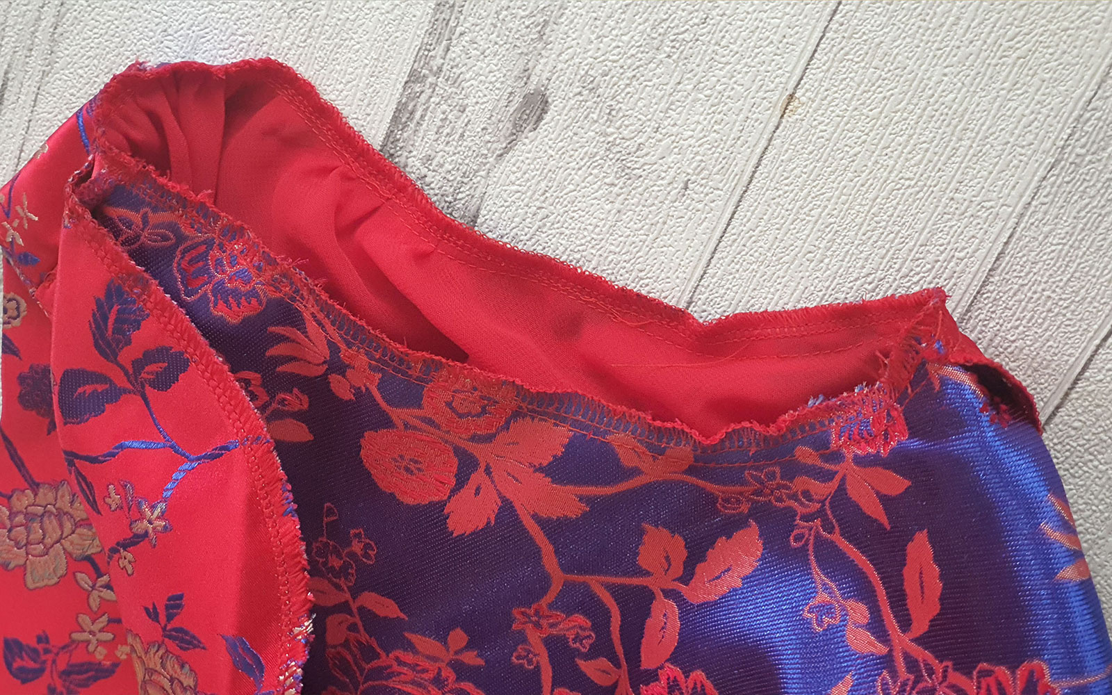 Close up of gathering stitches of red drafting balloon sleeve