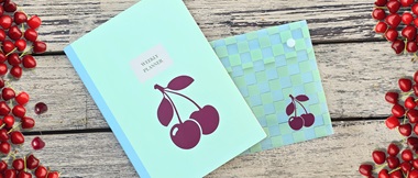 Burgundy cherry designs on blue notebook and file