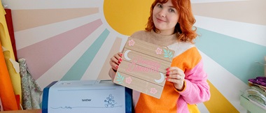 Paige Joanna holds Sweet Dreams wall sign with Brother ScanNCut