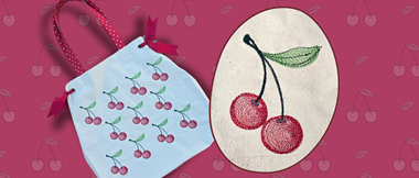 Machine embroidered cherry design on white bag
