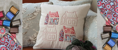 beige cushion with red outline schoolhouse embroidery and appliqué