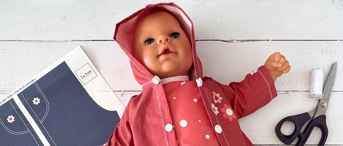 Doll with red clothes and printed pattern pieces.