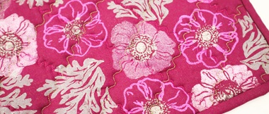 Pink floral block printed quilted trivet close up