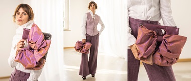Model holding pink handbag bag with big bow