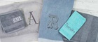Embroidered towels on wooden background