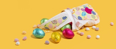 small white bag with Easter bunny face stitched on and eggs 