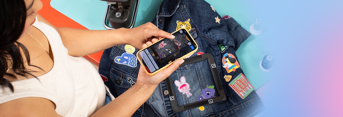 Woman positioning design on jacket with smartphone camera