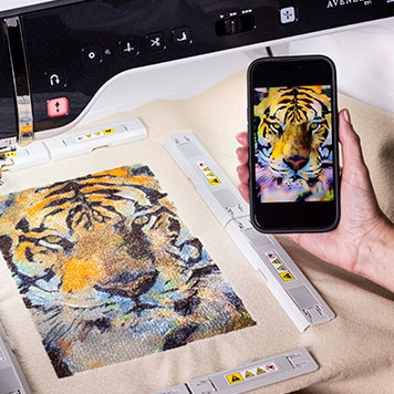 Tiger image on tablet, Brother EV1 screen, and in embroidery frame.