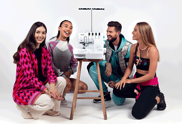 4 people kneeling around Brother Airflow 3000 Overlocker