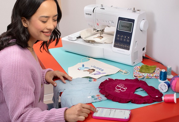 woman sending embroidery data from phone to machine