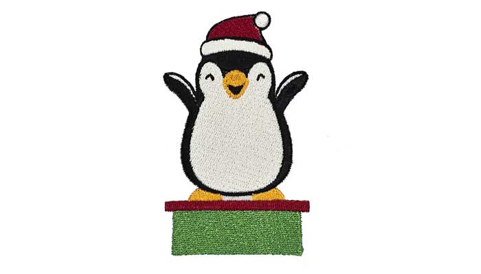 Penguin with christmas hat on green stand embroidery