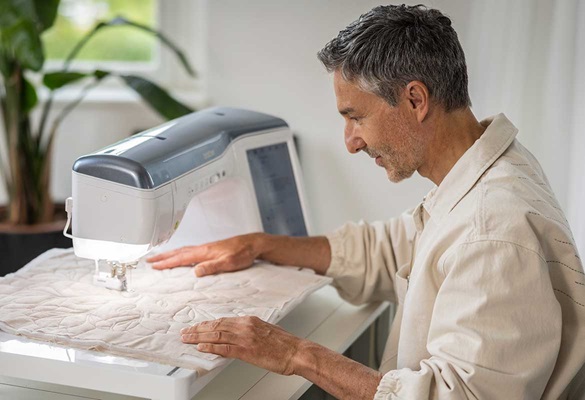 Man quilt met Brother CX1 – ruim werkvlak en geavanceerde functies.