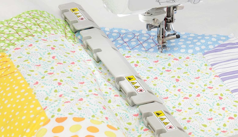 Pastel quilt and magnets of magnetic frame on light grey background