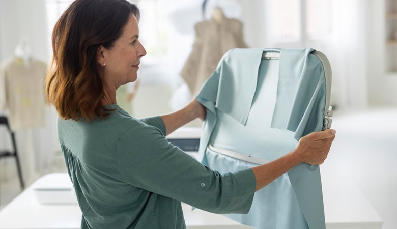 Woman holding Brother’s biggest Aveneer EV1 embroidery frame