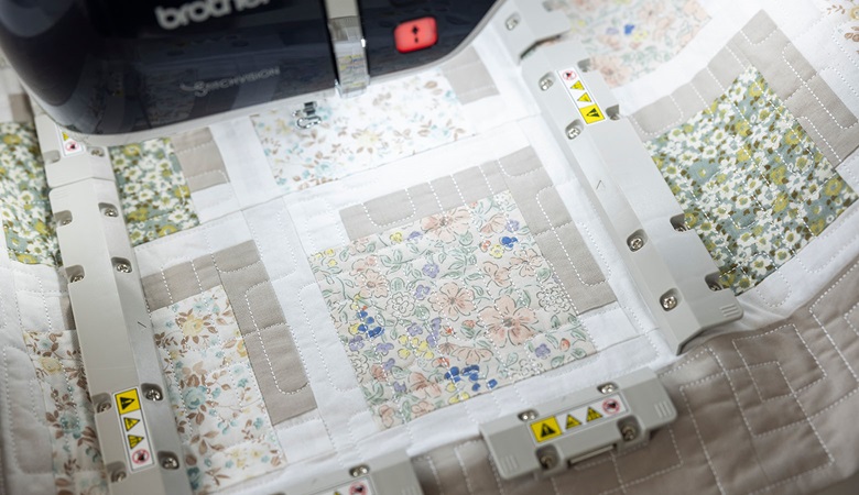 Brown and white quilt with floral squares in EV1’s magnetic frame