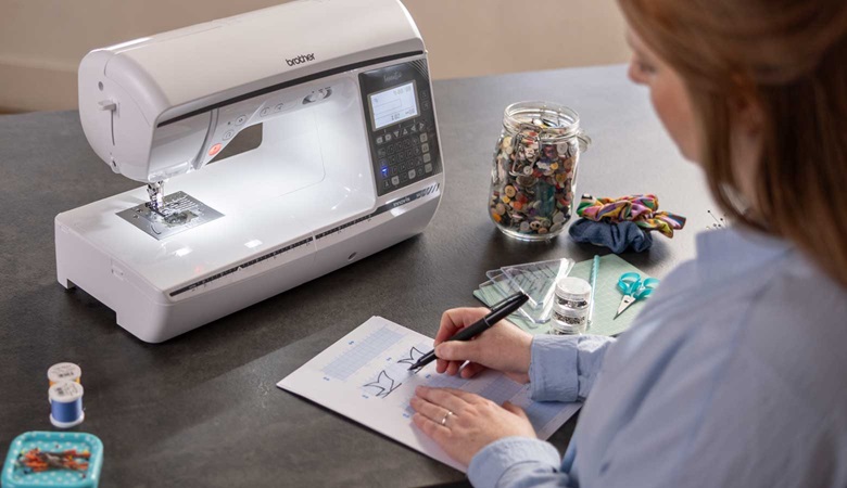 A lady creating customised stitches to be used on the machine.