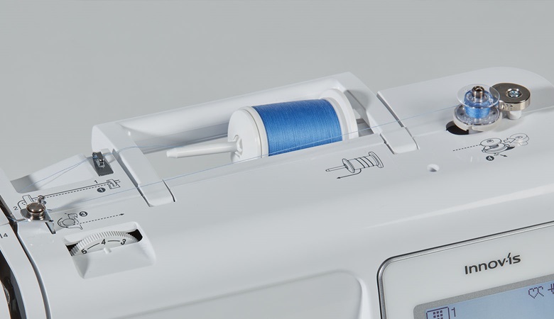 Close up of bobbin winding system and thread cutter