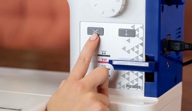 Finger pressing cutter button on Brother PQ1600S sewing machine