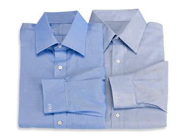 Blue formal shirts with white initials embroidered on cuffs
