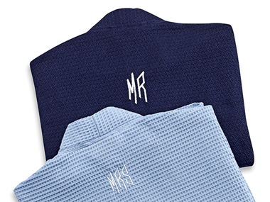 Two blue robes with Mr and Mrs embroidered on the backs