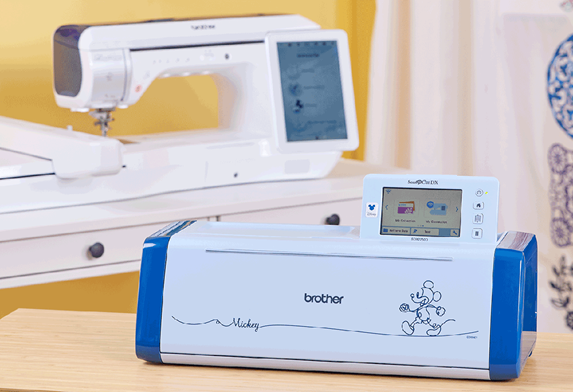 Blue ScanNCut in front of Luminaire XP sewing machine
