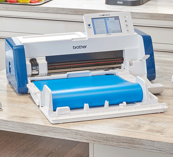 Roll feeder with blue vinyl roll attached to ScanNCut SDX2200D