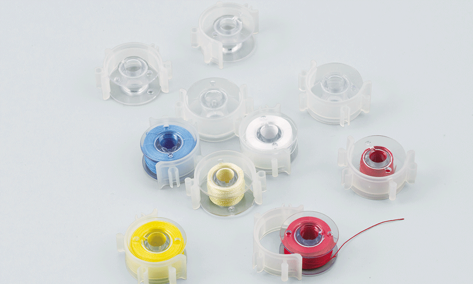 Clear plastic sewing machine bobbins with clips BCL