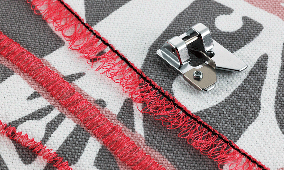 Metal fringe foot F025N on fabric next to 3 rows of red fringing