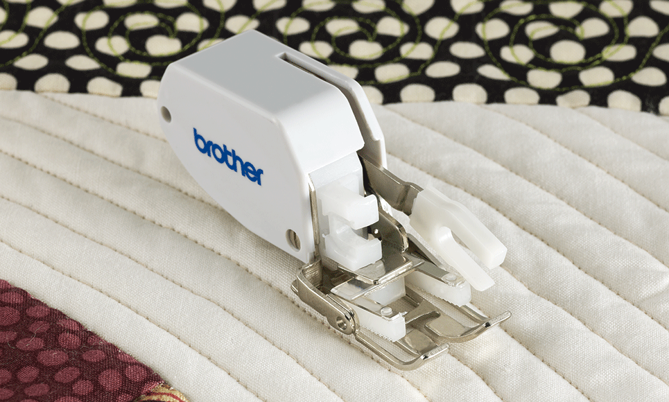 Walking foot attachment on white and black quilt with parallel sewing